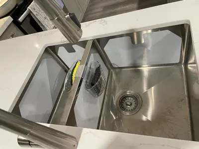 a kitchen counter with a sink with a sink at Bright & Cozy Basement Retreat in Oshawa