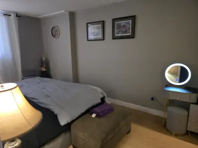 a bedroom with a bed and a mirror on the wall at Simple entire apartment 2 bedroom night rest in Kitchener