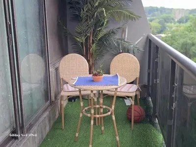 a table and chairs on a balcony with a plant at Simple entire apartment 2 bedroom night rest in Kitchener