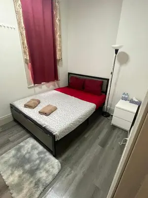 a bedroom with a bed with red sheets and a window at Homestay At Queen St-Downtown Toronto-Free Wifi N in Toronto