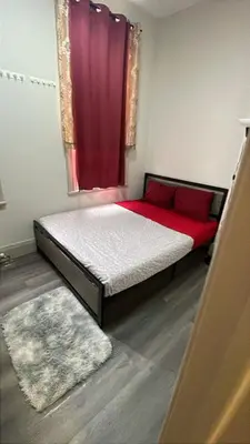 a bedroom with a bed with a red curtain at Homestay At Queen St-Downtown Toronto-Free Wifi N in Toronto