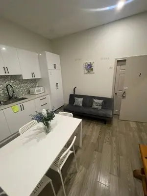 a kitchen and living room with a table and a couch at Homestay At Queen St-Downtown Toronto-Free Wifi N in Toronto