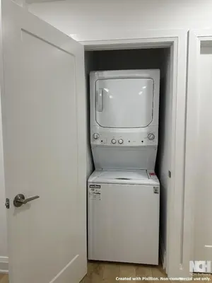 a tv sitting on top of a refrigerator in a room at Modern 2-Bedroom Apartment in Luxury Home with Gym in Richmond Hill
