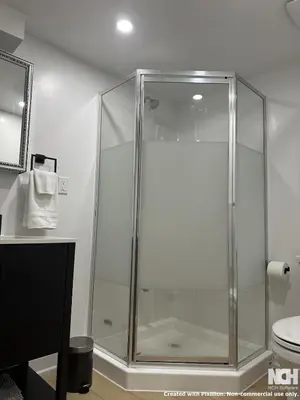 a glass shower in a bathroom with a toilet at Modern 2-Bedroom Apartment in Luxury Home with Gym in Richmond Hill