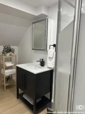 a bathroom with a sink and a mirror at Modern 2-Bedroom Apartment in Luxury Home with Gym in Richmond Hill