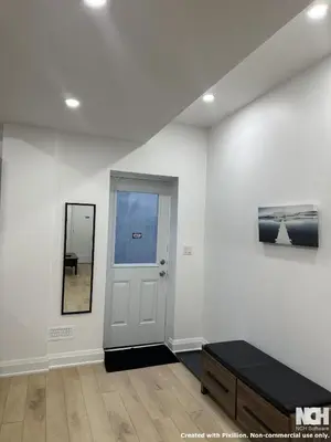 a white room with a door and a mirror at Modern 2-Bedroom Apartment in Luxury Home with Gym in Richmond Hill