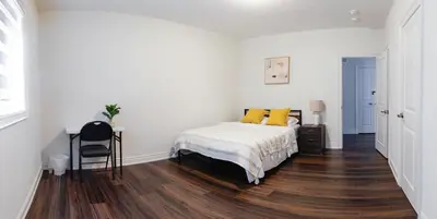 a bedroom with a bed with yellow pillows on it at Very Modern New Luxury House in RichmondHill in Richmond Hill