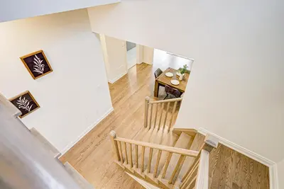 an overhead view of a staircase with a table in a room at Very Modern New Luxury House in RichmondHill in Richmond Hill