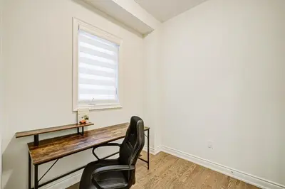 a desk and a chair in a room with a window at Very Modern New Luxury House in RichmondHill in Richmond Hill