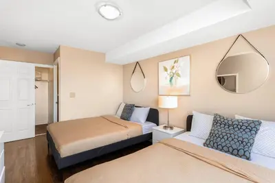 a bedroom with two beds and a mirror at High-Rise Luxury 3 BR/2BA | Spectacular 180° Views in Mississauga