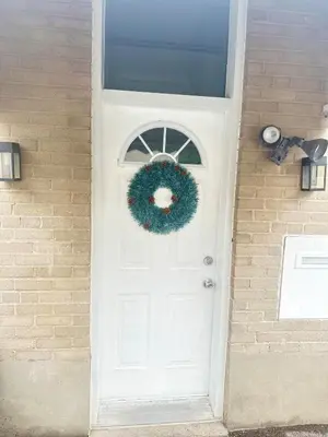 a white door with a christmas wreath on it at Soft Landing Spot Basement Hideout 2 bedroom apartment in Ajax