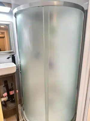 a metal shower in a bathroom with a sink at Soft Landing Spot Basement Hideout 2 bedroom apartment in Ajax