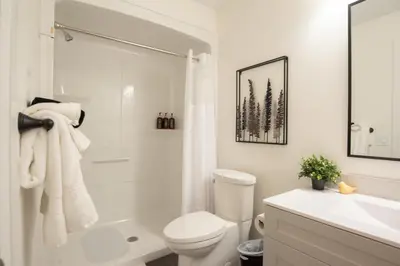 a white bathroom with a toilet and a sink at Downtown Stratford - The Blowes Inn in Stratford