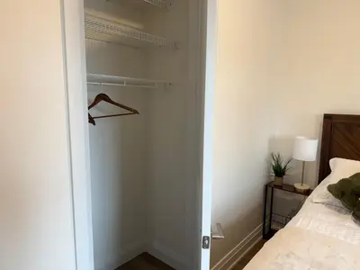 a bedroom with a closet and a bed at Downtown Stratford - The Blowes Inn in Stratford