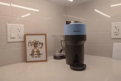 a coffee maker sitting on a counter next to a picture at Downtown Stratford - The Blowes Inn in Stratford
