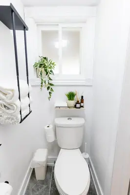 a white bathroom with a toilet and a window at Private 2-BR Suite w Patio in Mississauga