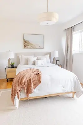 a bedroom with a white bed with a blanket on it at Private 2-BR Suite w Patio in Mississauga