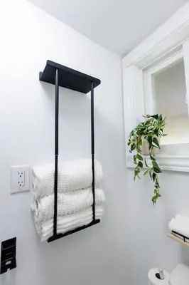 a black towel rack in a bathroom with towels at Private 2-BR Suite w Patio in Mississauga