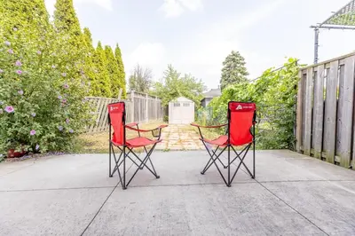 two red chairs sitting next to each other on a patio at Private 2-BR Suite w Patio in Mississauga