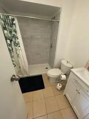 a small bathroom with a toilet and a shower at Affordable Toronto Downtown Bloor Stay in Toronto