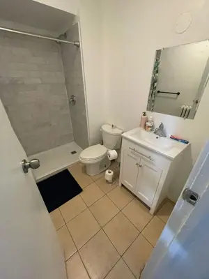 a bathroom with a toilet and a shower and a sink at Affordable Toronto Downtown Bloor Stay in Toronto