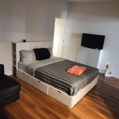 a bedroom with a bed with a black and white comforter at Sweet Home in Bloor Downtown-CENTRAL STAY in Toronto