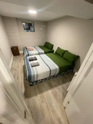 a bedroom with two beds with green pillows at Sweet Home in Bloor Downtown-CENTRAL STAY in Toronto