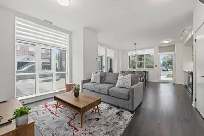 a living room with a couch and a table at Chic 2-Bedroom Apartment with Parking in Toronto