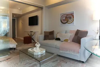a living room with a couch and a table at Cozy Studio in the heart of Yorkville in Toronto