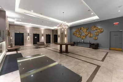 a lobby with a table in the middle of a room at Cozy Studio in the heart of Yorkville in Toronto