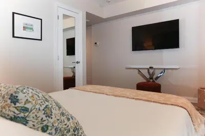 a bedroom with a bed and a flat screen tv at Cozy Studio in the heart of Yorkville in Toronto