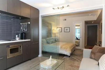 a living room with a kitchen and a bedroom at Cozy Studio in the heart of Yorkville in Toronto