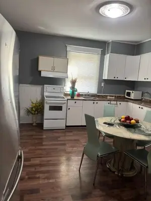 a kitchen with a table with a bowl of fruit on it at Woodbridge Heritage Home in Vaughan