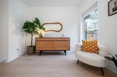a living room with a dresser and a chair at Luxury Group Stay in King West in Toronto