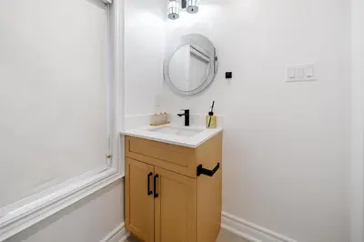 a bathroom with a sink and a mirror at Luxury Group Stay in King West in Toronto