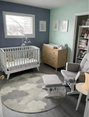 a baby room with a crib and a chair at Family home in Hamilton