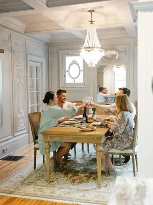 a group of people sitting around a table with wine glasses at Guestroom in Old Town | Steps to Lake & Everything in Niagara on the Lake