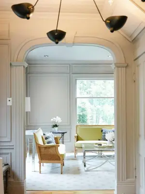 an archway in a living room with a couch and a table at Guestroom in Old Town | Steps to Lake & Everything in Niagara on the Lake