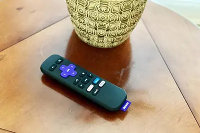 a remote control sitting on a table next to a vase at Top 1% Quiet Private Guestroom 2ppl Old Town NOTL in Niagara on the Lake