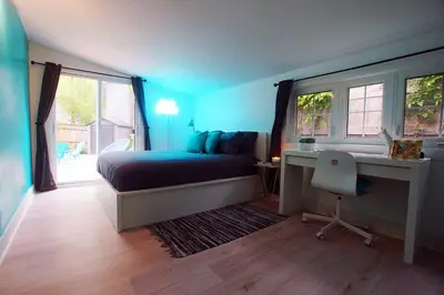 a bedroom with a bed and a desk and window at The Coupe: A Hip Wine Lovers Retreat in NOTL! ✌️ in Niagara on the Lake