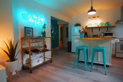 a kitchen with a counter and two stools in a room at The Coupe: A Hip Wine Lovers Retreat in NOTL! ✌️ in Niagara on the Lake