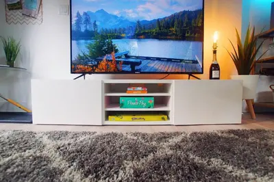 a flat screen tv sitting in a living room at The Coupe: A Hip Wine Lovers Retreat in NOTL! ✌️ in Niagara on the Lake