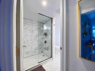 a bathroom with a shower with a glass door at The Coupe: A Hip Wine Lovers Retreat in NOTL! ✌️ in Niagara on the Lake