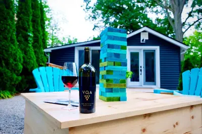a bottle of wine and a glass on a table at The Coupe: A Hip Wine Lovers Retreat in NOTL! ✌️ in Niagara on the Lake