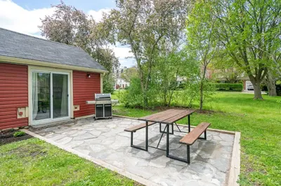a patio with a picnic table and a grill at Top 5% Tiny Home by River/Lake in Old Town NOTL in Niagara on the Lake