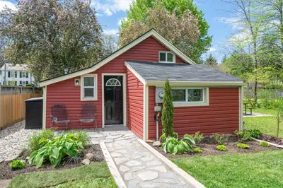a red tiny house with a patio at Top 5% Tiny Home by River/Lake in Old Town NOTL in Niagara on the Lake