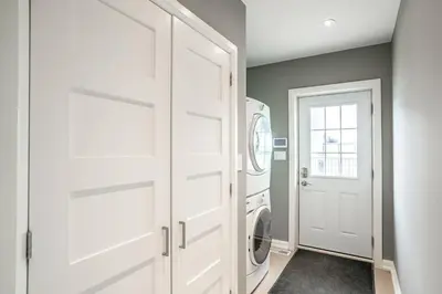 a white laundry room with a washer and dryer at Vineyard 2 Bed Farm Home | Mins to Town & Wineries in Niagara on the Lake