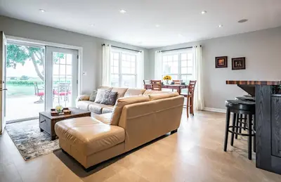 a living room with a couch and a table at Vineyard 2 Bed Farm Home | Mins to Town & Wineries in Niagara on the Lake