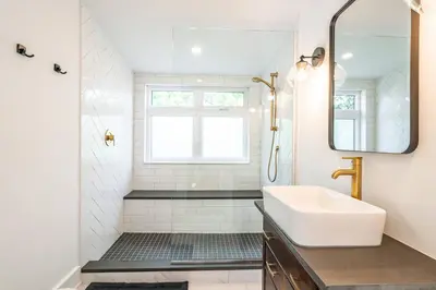 a white bathroom with a sink and a mirror at Central Historic Cottage 4ppl in Heart of NOTL in Niagara on the Lake