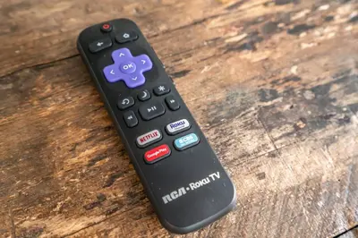 a remote control sitting on top of a wooden table at Central Historic Cottage 4ppl in Heart of NOTL in Niagara on the Lake